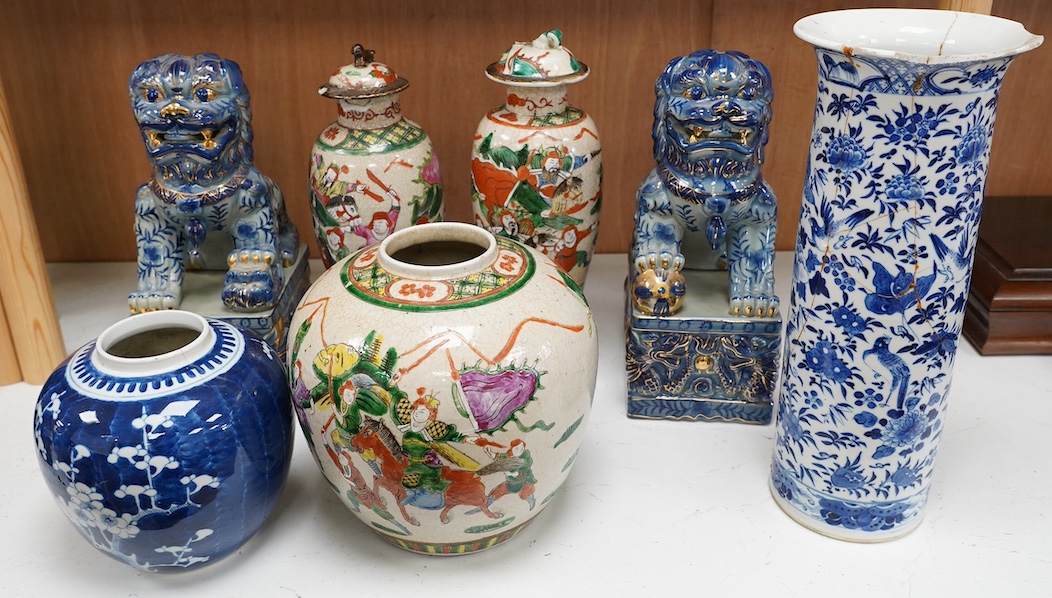 A group of Chinese ceramics including a large blue and white sleeve vase, circa 1900, two crackle glazed vases and covers, similar jar, a prunus jar and a pair of lion dogs, largest 36cm (7). Condition - poor to fair